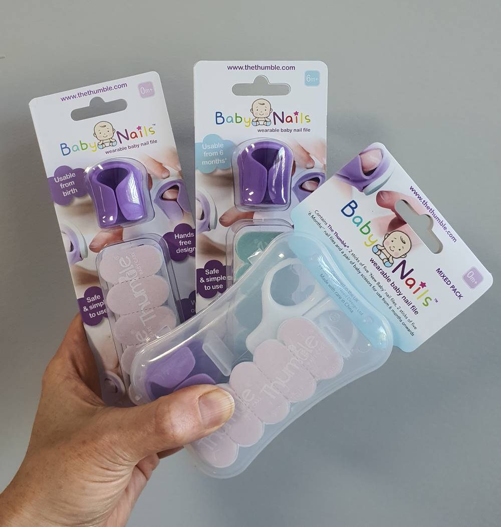 Hand holding Baby Nails 0m+, 6m+ and Mixed Pack packaging by Thumble Baby Care.