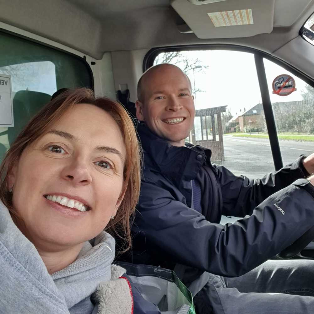 Thumble Baby Care founders smiling in a delivery van on moving day.